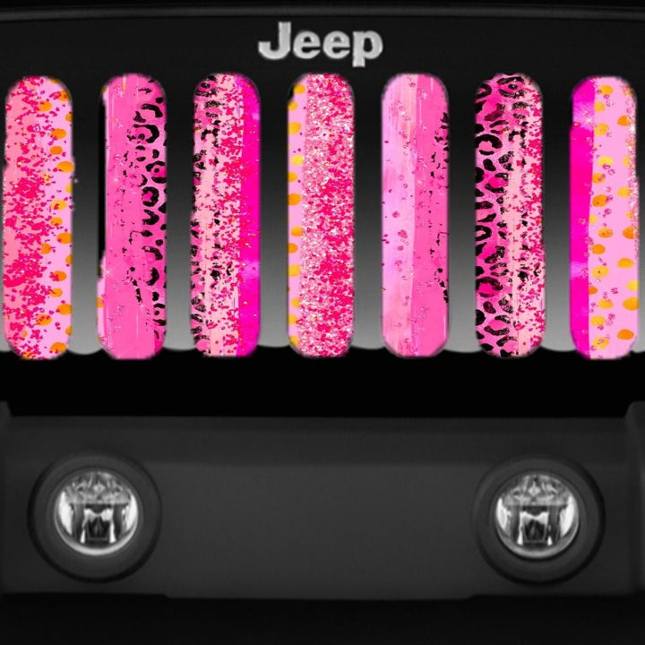 Close up view of a blend of pink animal cheetah leopard print designed grille insert for Jeep.