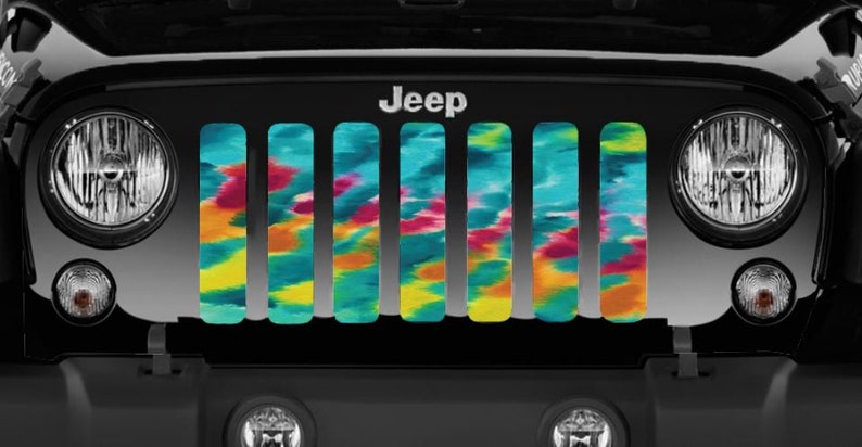 Very close view of Turquoise Tie Dye Design Grille Insert for Jeep on a black Jeep Wrangler.