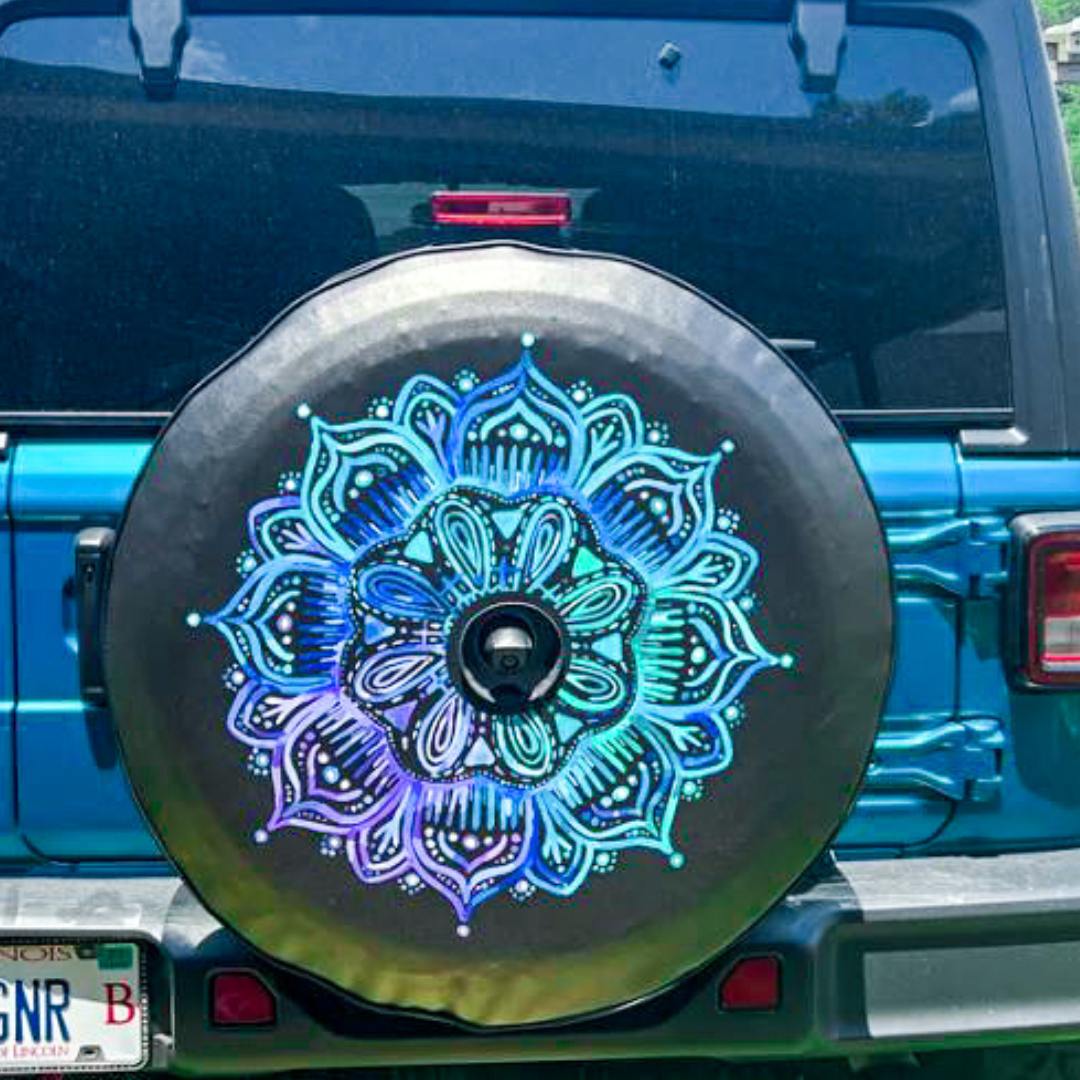 Teal and purple mandala flower design printed on black vinyl with a back up camera and installed on a bikini pearlcoat Jeep.