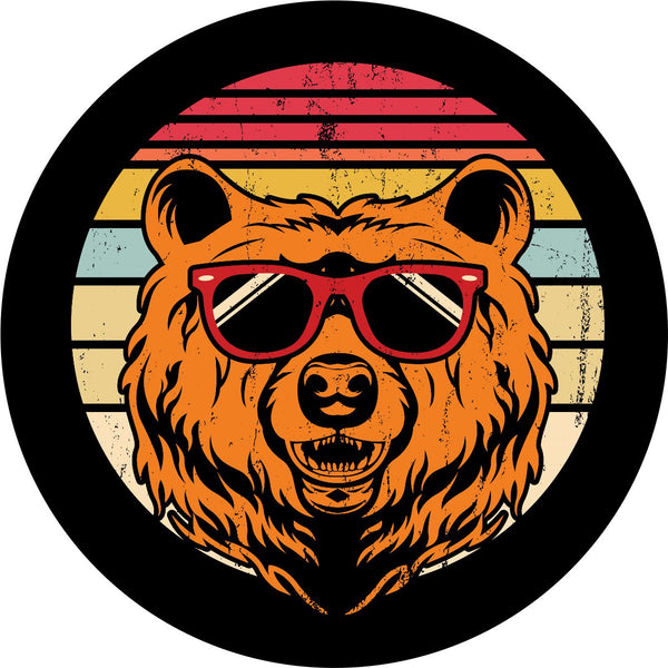 Spare tire cover on black vinyl of red, yellow, and cream stripes in the background with a rustic vintage look and a bear head wearing sunglasses. 