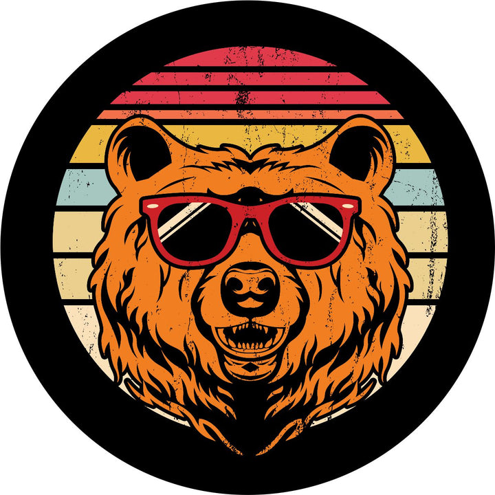 Spare tire cover on black vinyl of red, yellow, and cream stripes in the background with a rustic vintage look and a bear head wearing sunglasses. 