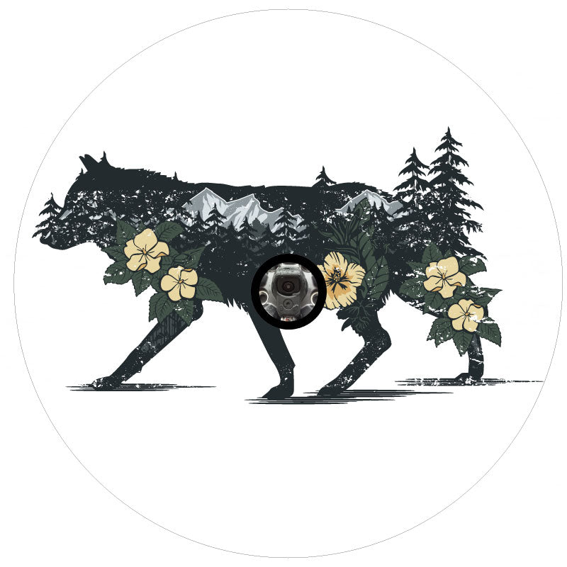dark silhouette of a wolf unique spare tire cover design with the wild wilderness mountains, trees and flowers double exposed inside the wolf on white vinyl with a back up camera